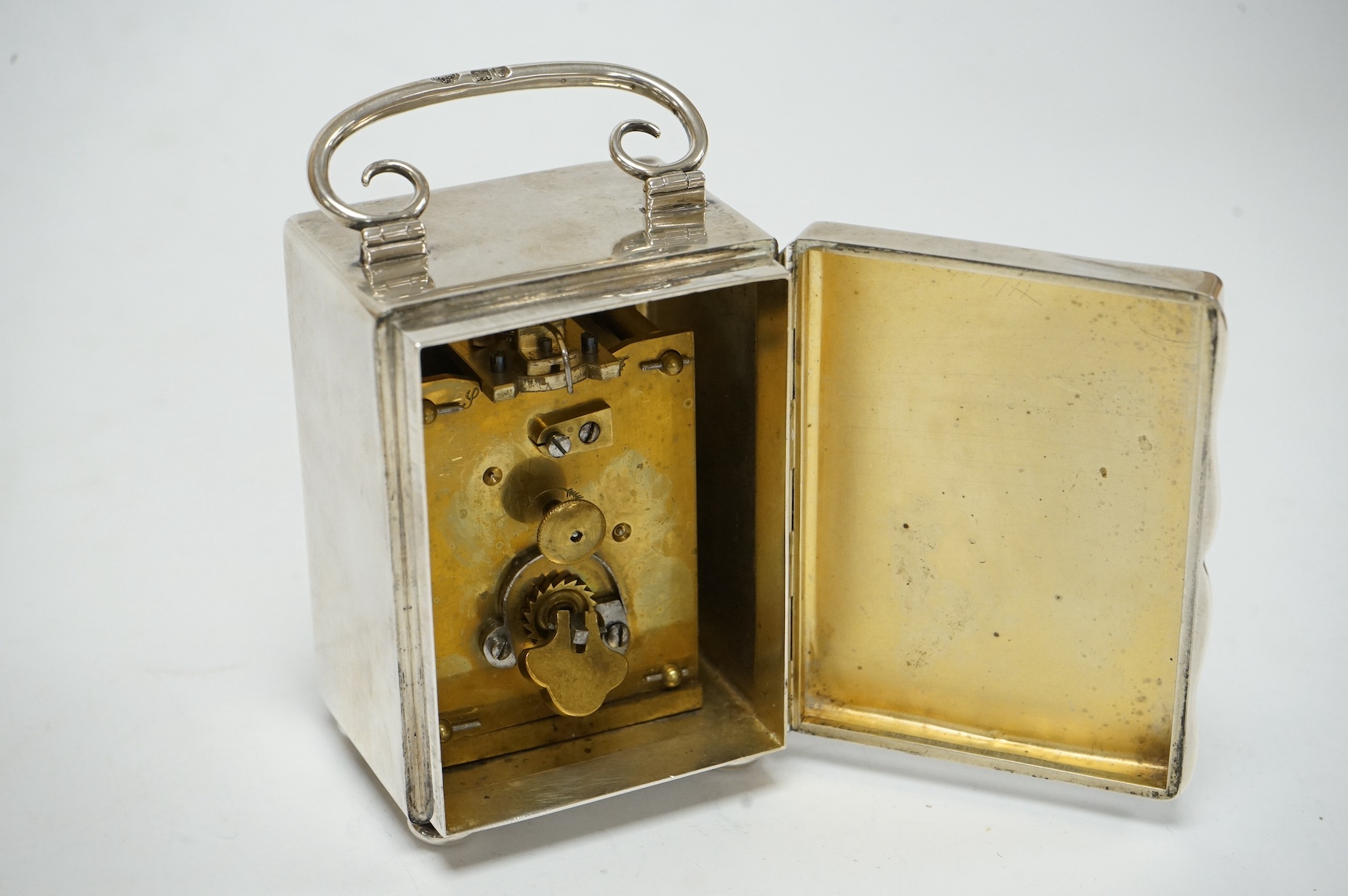 An Edwardian silver cased carriage timepiece, with Arabic dial, on bun feet, by Goldsmiths & Silversmiths Co Ltd, London, 1904, 85mm excluding the handle. Condition - poor